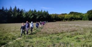 Group of people walking across a field for Boots On Adventures in Kent